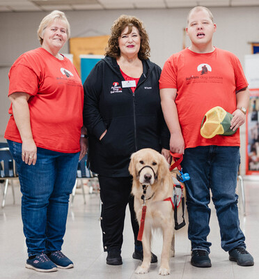 Past Hydro One Energizing Life Community Fund recipients, Autism Dog Services (ADS) help launch 2024 fund in Ancaster, Ontario. (Left to right) Vicki Spadoni, ADS Executive Director, and Adele Alfano, Vicki's son Adam, and his service dog Henry. (CNW Group/Hydro One Inc.)
