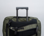 Back mesh padding doubles as wheeled suitcase handle passthrough