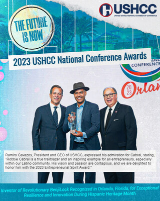 Robbie Cabral proudly accepts the 2023 Entrepreneurial Spirit Award, joined by industry leaders Nelson Reyneri Jr., Chairman of NRG, and Ramiro Cavazos, President & CEO of the United States Hispanic Chamber of Commerce.