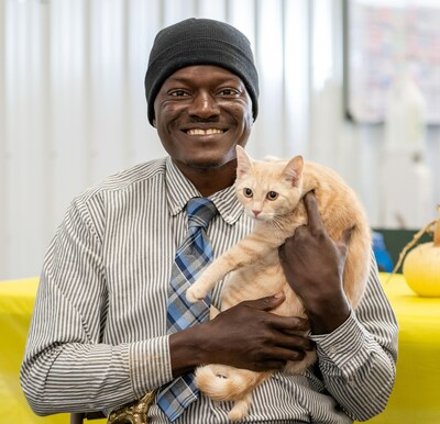 Fred, a Rapid Shelter Columbia resident, and his emotional support cat, Draco.