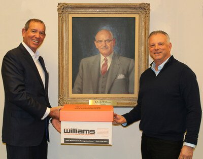 Williams Data Management transfers ownership to 4th generation of Williams family. Featured: Douglas C. Williams, (left) poses with Matthew Casden (right) next to portrait of founder John J. Williams.