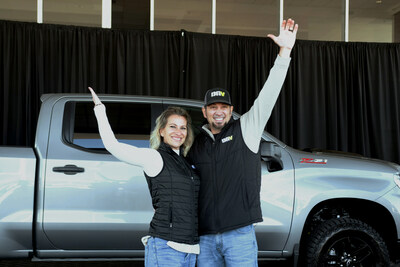 Adam and his wife with their new Chevy Silverado