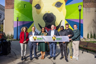 Release the hounds! With a ribbon cutting, Mulligan's Bark Park is officially open. From left: Rebecca Fleischaker, Executive Director, Louisville Downtown Partnership; Craig Greenberg, Mayor of the City of Louisville; Mutt Mulligan, TurfMutt Foundation Spokesdog; Ameerah Palacios, President, Louisville Downtown Residents Association; Kris Kiser, President of the TurfMutt Foundation; mural artist Kacy Jackson; and landscape contractors Jordan and John Steele of Steele Blades.