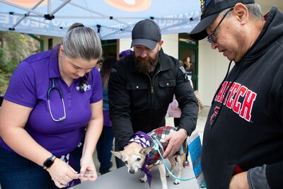 Rowdy, pictured here with pet parent Larry at a free vaccine clinic in San Antonio, Texas, received the two-millionth free pet vaccine distributed by Petco Love to community pets as part of its Vaccinated and Loved initiative.