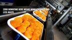 Food manufacturing photo, food on an assembly line with a caption stating, "Zero downtime here means more product and less waste."