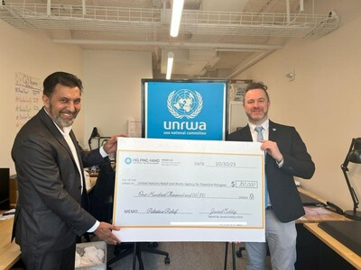 UNRWA accepts check from Helping Hand staff