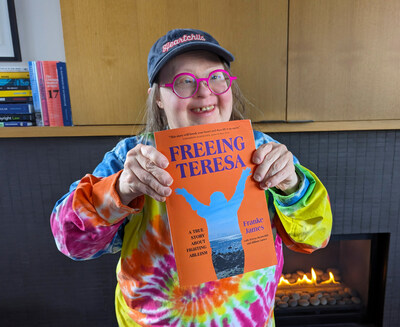 Teresa Heartchild holds up the book "Freeing Teresa" which tells how she lost -- and then regained -- her freedom ten years ago. (Photo by Billiam James)
#FreeingTeresa #truestory #Downsyndrome #forcedcare #activist #memoir #disabilityrights (CNW Group/The James Gang, Iconoclasts Inc.)