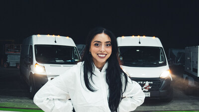 Victoria Vallone, Bio Recovery Group owner and CEO, pictured in front of work vans.