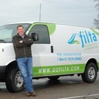 Terry Walkerly stands in front of one of the more than 50 vans in his fleet.