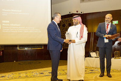 SOCPA's CEO, Dr. Ahmad Al-Meghames receiving a plaque of appreciation from IMA's president and CEO, Michael DePrisco