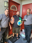 AMC Community Directors deliver Thanksgiving dinner items to a resident of one of their communities.