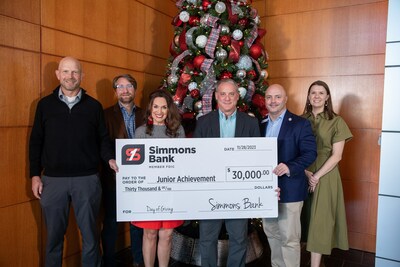 Simmons Bank (right) present the donation to Junior Achievement representatives (left).