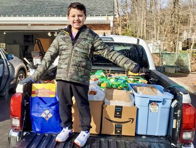 10-year-old Dante-Olshefski helped load a truck during his food drive in Denville, NJ, in 2022.