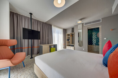 Guest rooms at the Quadro feature light wood furnishings, playful textures and colorful accents.