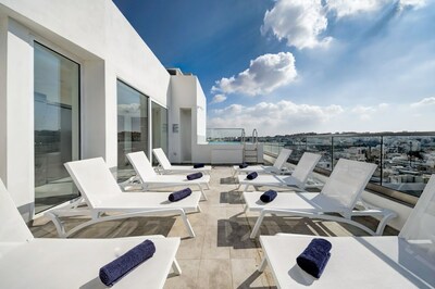 The seasonal rooftop pool at the Quadro offers panoramic views of St. Julian's.