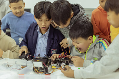 Pure joy radiates as these young minds celebrate their first triumph in robotic coding at Unitel HUB