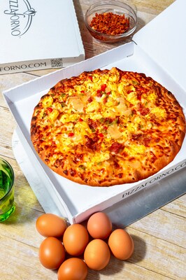 The breakfast pizza features a new and improved golden pizza crust layered with mozzarella and cheddar cheese, precooked eggs, bacon, ham, onions, green and red peppers.