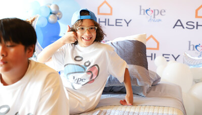 Child receiving new bed from Hope to Dream