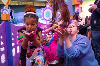 These kids believe blowing the confetti back into the air will help make wishes come true -- just like dandelion fluff