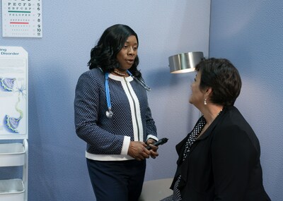 Nurse practitioner speaks with patient in clinic