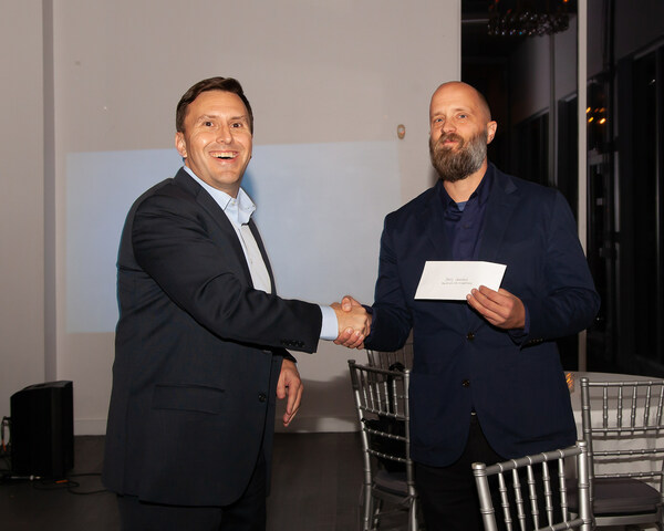 ESM Managing Partner Dave Hassard presenting a donation to Adam Jaeger of the Hudson County Boys and Girls Club