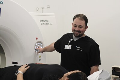 BayCare Outpatient Imaging CT technologist Colby Shull shares a comforting smile as he prepares a patient to enter a CT unit at BayCare Outpatient Imaging (South Tampa).