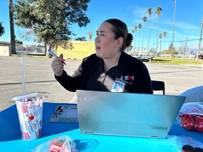 Mayra Nava-Flores, an IEHP Covered enrollment specialist, speaks with a San Bernardino resident about how to register for health care coverage through Covered California.