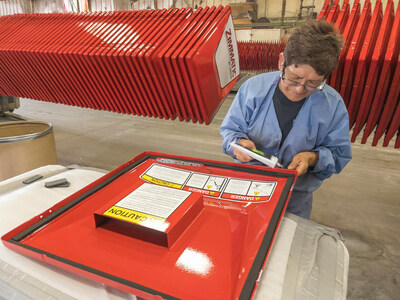 A Lindsay employee paints control panels for Zimmatic center pivot irrigation systems. Lindsay's manufacturing facility will undergo a <money>$50 million</money> expansion, solidifying Lindsay's investment in a strong rural workforce.