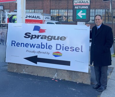 Steven Levy, Sprague's Managing Director of New Business Development, stands in front of Sonomax's sign promoting New York's first public renewable diesel station. Renewable diesel is a seamless replacement for conventional fossil fuel diesel, delivering significant environmental and public health benefits, without sacrificing performance. Sprague will continue to expand its supply of renewable diesel across its Northeast footprint to serve the transportation and home heating markets.