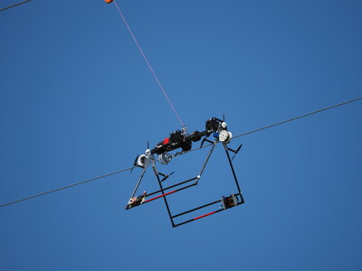 The Mini LineFlytm automatically and precisely installs PLP BIRD-FLIGHTtm Diverters on overhead conductors
