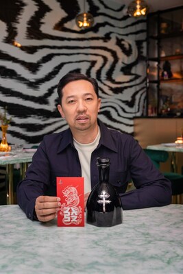 Humberto Leon showcasing his original designs on the front of the limited-edition D'USSÉ XO x Humberto red envelope, and a bottle of D'USSÉ XO.