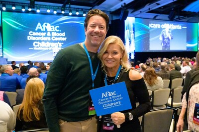 Aflac broker team members Krista and Jeff Price take part in Aflac’s auction at the company’s annual sales meeting. Aflac’s agents and brokers raised $770,000 for the Aflac Cancer and Blood Disorders Center in Atlanta.