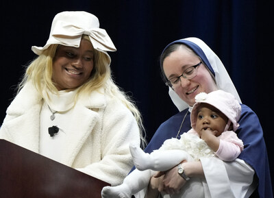 Life Fest before the March for Life in Washington Jan. 19, 2024. / Raisa (left), a mother who shared her testimony at Life Fest, smiles at one of her daughters in the arms of Sister Charity. Raisa was pursuing a music career when she learned she was pregnant with twins and turned to the Sisters of Life for help. Raisa also performed a song she wrote called 