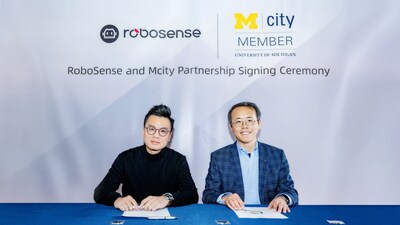 Mark Qiu, Executive President and Executive Director of RoboSense, joins Henry Liu, director of Mcity and a professor of Civil and Environmental Engineering at U-M, for the signing ceremony formalizing the partnership between RoboSense's partnership and Mcity.