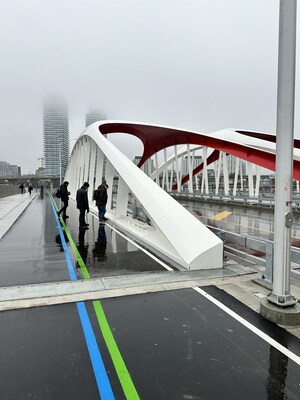 Team members from Entuitive and Grimshaw inspect their design work on the newly opened Cherry St. North Bridge (CNW Group/Entuitive)