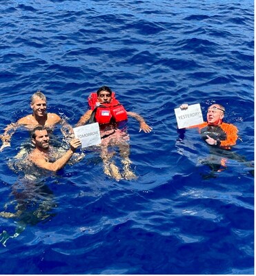DSV team taking a swim at the very spot where the international dateline crosses the Pacific Ocean - very near location of discovery. (L to R starting in back) Harald Aagedal, Tony Romeo, Mahesh Pichandi, Craig Wallace. (PRNewsfoto/Deep Sea Vision)