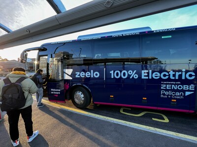 Passengers board an electric Zeelo bus to commute to work