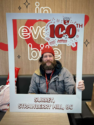 A customer is all smiles after becoming one of the day's first 100 customers to check out Jollibee's new Surrey-Strawberry Hill location on Jan. 25, 2024 ? a milestone occasion, as it marked the joyful dining brand's 100th store opening in North America. (Photo credit: Jollibee)