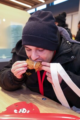Joy at First Bite! A happy hungry customer digs into Jollibee’s world-famous Jolly Crispy Chicken at its newest Surrey, BC, Canada grand opening on Friday, January 25, 2024.  (Photo credit: Jollibee)