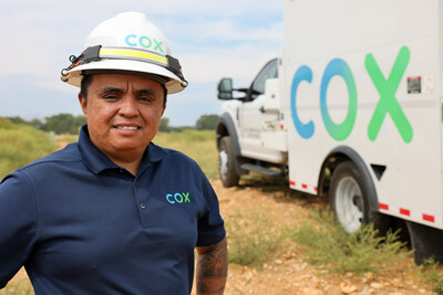 A Cox technician ready to deploy high-speed internet service to a community.