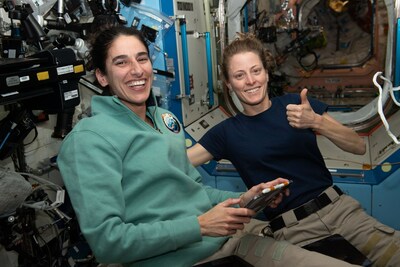 NASA astronauts and Expedition 70 Flight Engineers Jasmin Moghbeli, left, and Loral O'Hara in the Destiny laboratory celebrate the successful docking of a SpaceX Dragon cargo spacecraft to the International Space Station. Credits: NASA
