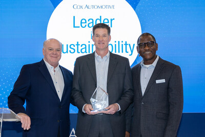 Cox Automotive President Steve Rowley (L) presents George Grubbs III (M), CEO Grubbs Family of Dealerships, the 2024 Leader in Sustainability Award with Roland Ambe (R), director of Environmental Sustainability at Cox Automotive.