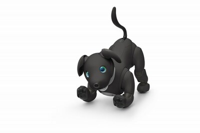 An ERS-1000B aibo Espresso Edition in a playful pose.