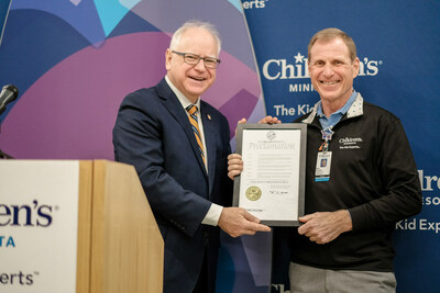 Minnesota Gov. Tim Walz (left) presenting the Children's Minnesota Day proclamation to Dr. Marc Gorelick (right), president and CEO of Children's Minnesota.