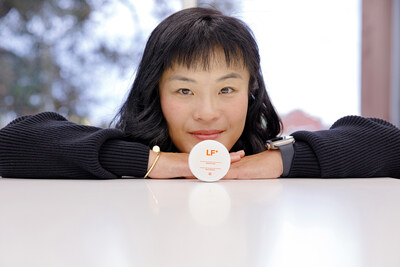 TurtleTree CEO and Co-Founder Fengru Lin and TurtleTree's world-first vegan-certified lactoferrin, LF+