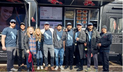 Franchisee Yunus Shahul celebrates the opening of his first Chicago food truck on February 10th, 2024, with Cousins Maine Lobster team and co-founders Jim Tselikis and Sabin Lomac. (PRNewsfoto/Cousins Maine Lobster)