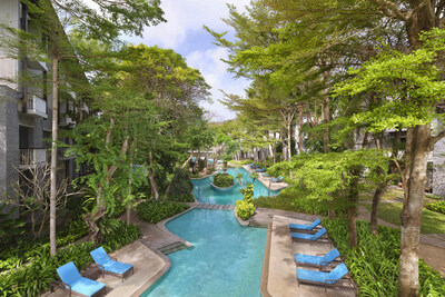 Located at the heart of our resort, the lagoon-shaped pool measures 97 x 33 meters and is surrounded by lush tropical gardens and an array of sun loungers.  (PRNewsfoto/Courtyard by Marriott Bali Nusa Dua Resort)