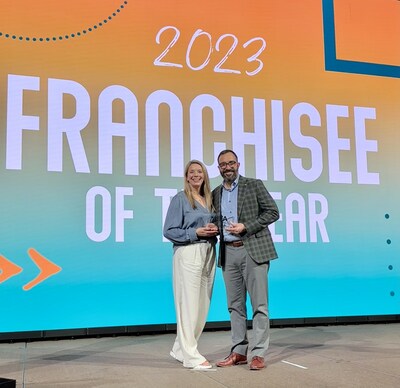 The Boswells accept the Franchise Owner of the Year Award at the International Franchise Association's 64th annual convention in Phoenix, AZ