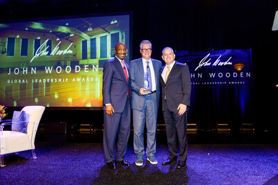 Kenneth C. Frazier, chairman of health assurance initiatives at General Catalyst and 2021 recipient of the John Wooden Global Leadership Award (left) and UCLA Anderson Dean Tony Bernardo (right) present the 2024 John Wooden Global Leadership Award to Delta Airlines CEO Ed Bastian (center).