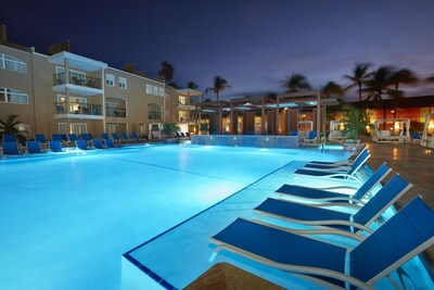 Pool lit at night at Divi Dutch Village Beach Resort